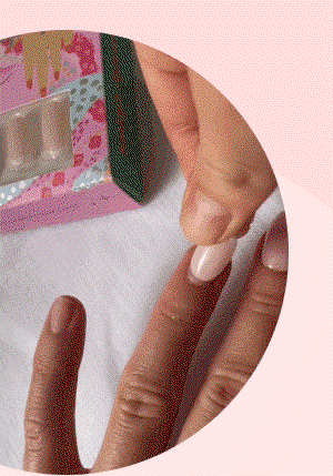 Hand wiping nails clean with white cloth, removing invisible oils that block adhesive