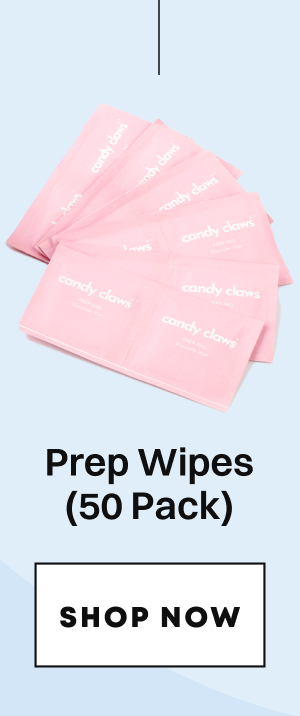 Stack of pink prep wipes package with candy claws branding and shop button