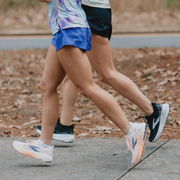 Two people running in Brooks shoes