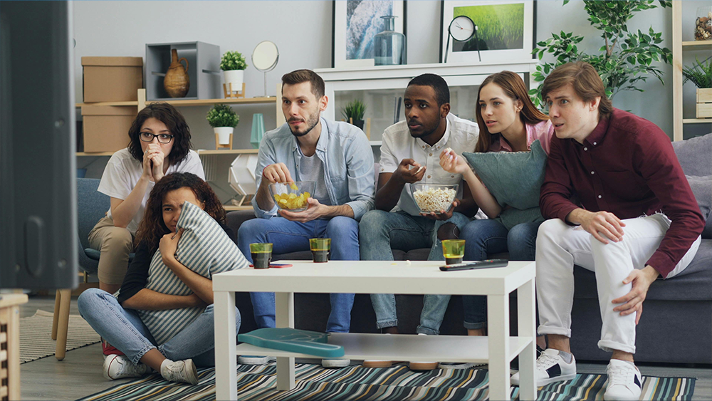 Friends watching a Spivo video of their epic vacation adventure
