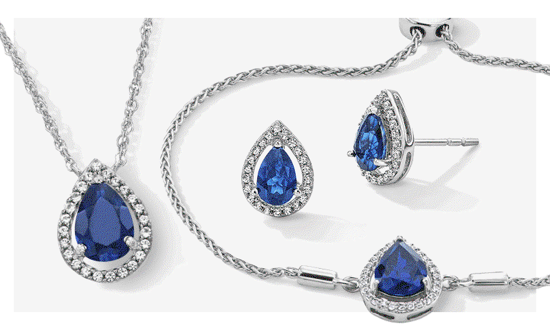 Rotating GIF featuring a set of blue sapphire and diamond jewelry, a station necklace and paperclip bracelet.