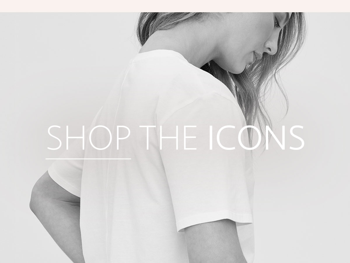 Close-up of a model wearing a white t-shirt with overlay text reading “Shop the Icons.”