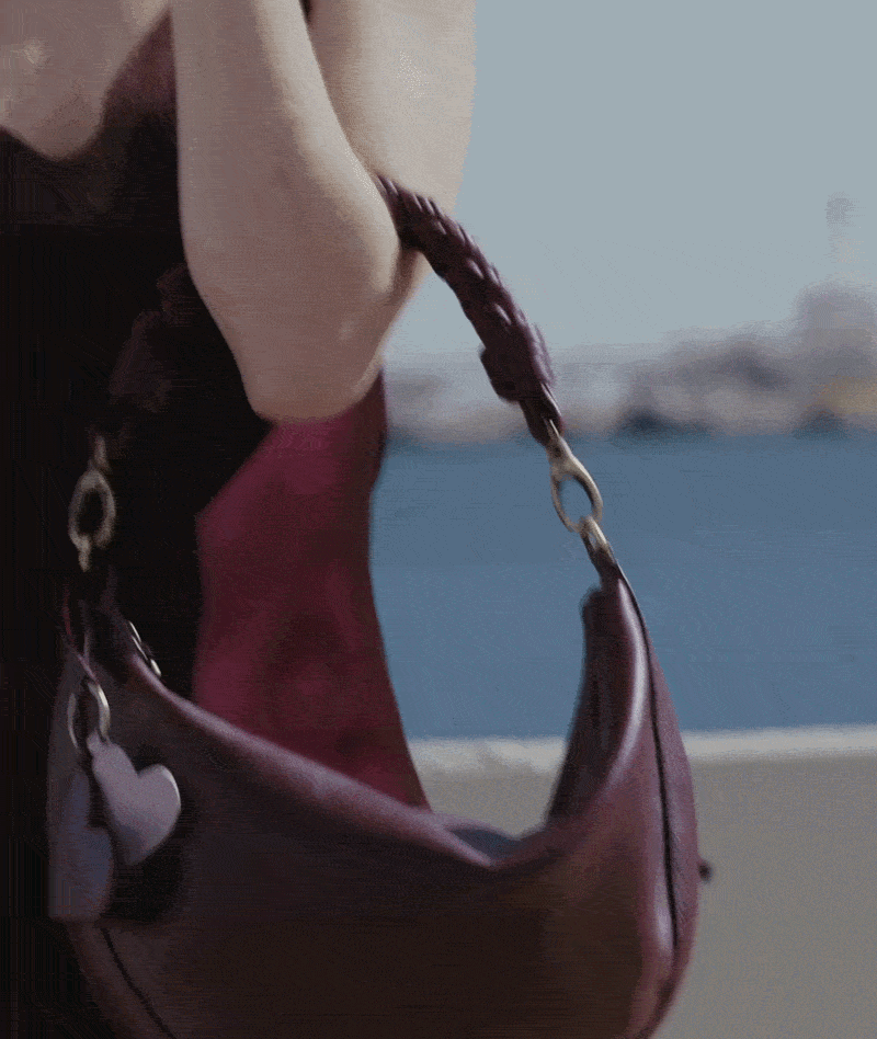 Woman wearing the Leo Maxi Twisted Handle in Dark Cherry