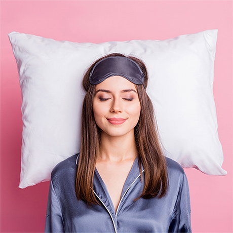 Woman lying in bed with eye mask