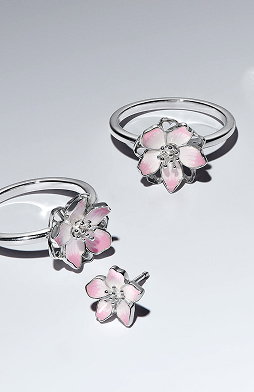 Cherry blossom sterling silver rings and earrings on surface