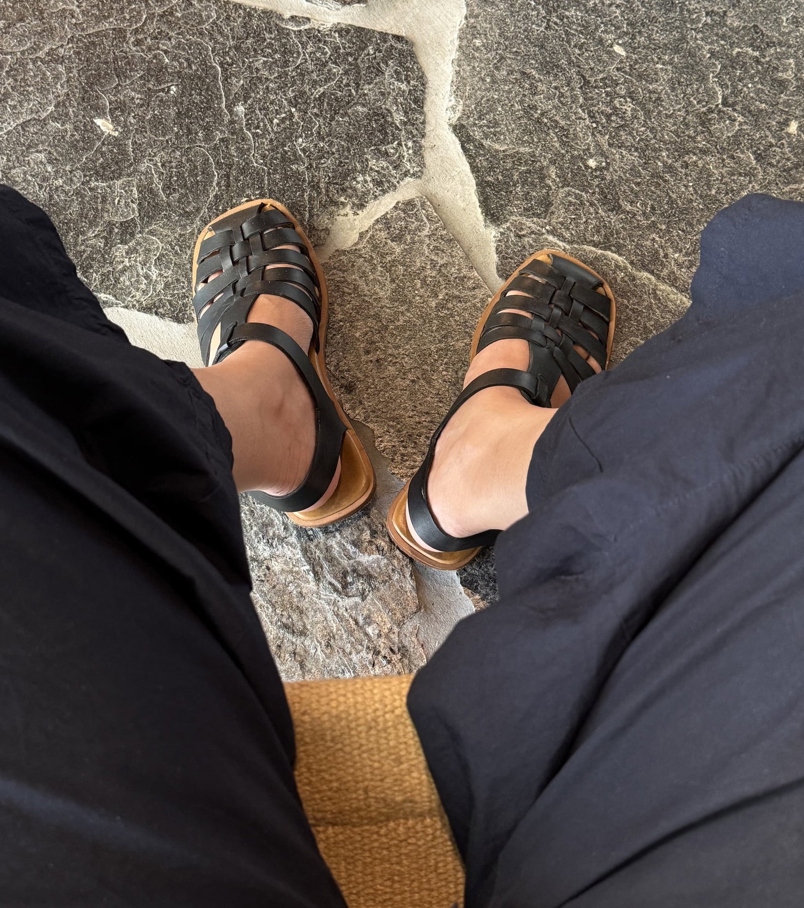 woman wearing black fisherman sandals