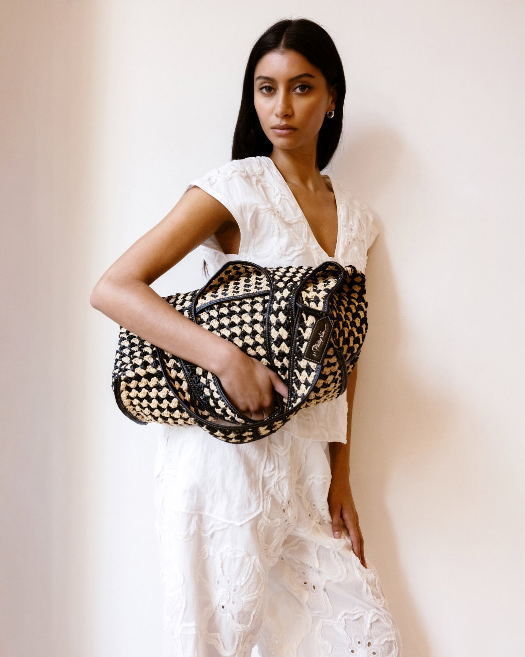an image of a woman in a white dress holding a purse