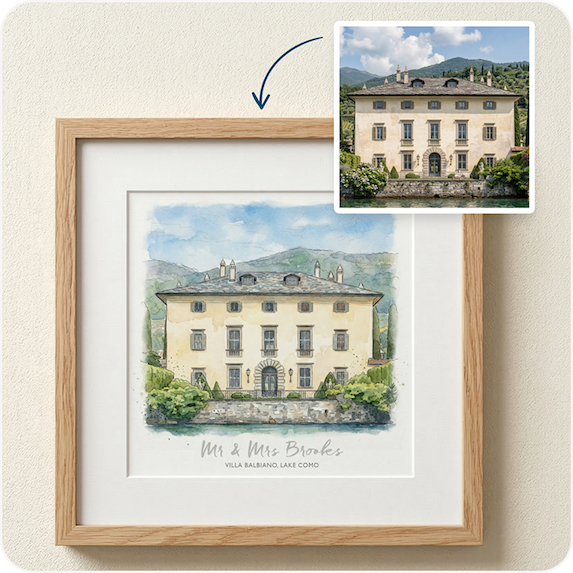 A framed watercolour sketch of a wedding venue alongside a reference photo, displayed in a natural wood frame