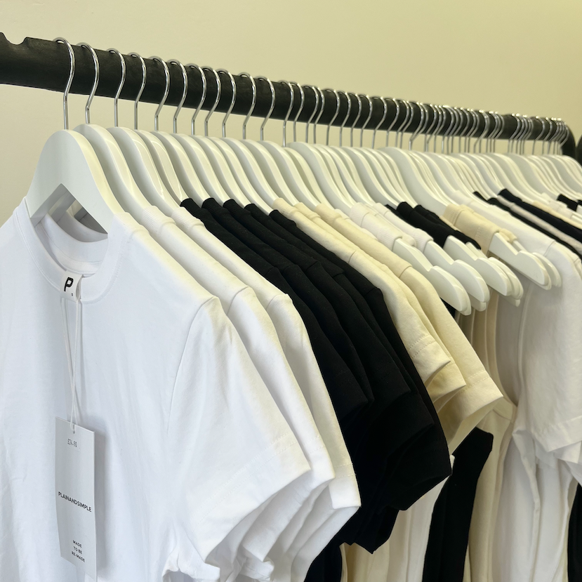 http://A rail of plain organic cotton t-shirts and tank tops.