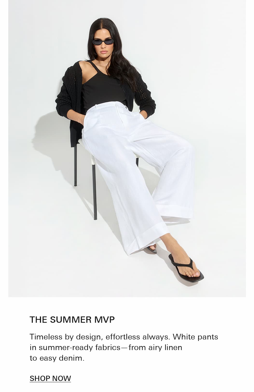 woman wearing a black knit and terrace white pant