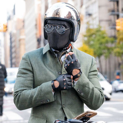 The suited racer wearing leather fingerless gloves in the city