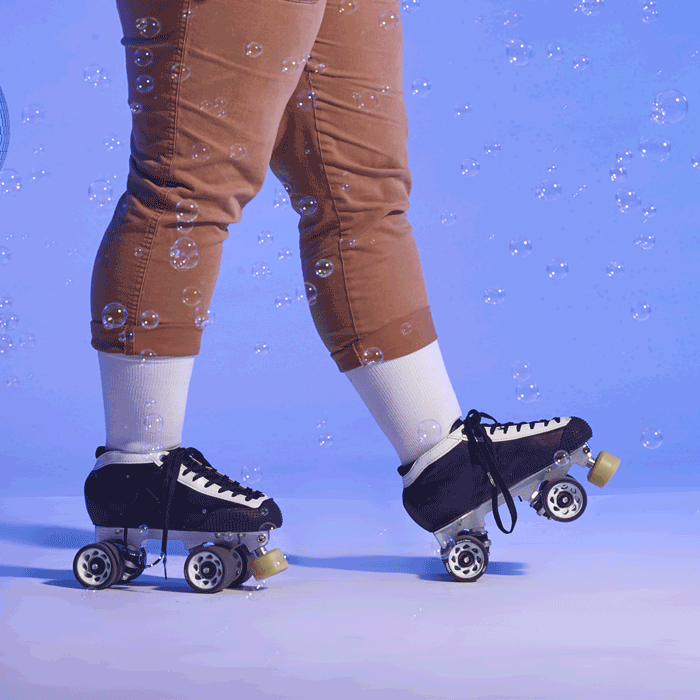 Your Feel Your Way - a gif of a woman in roller skates wearing a white lightweight sock and a woman's legs showing blue cushioned sock with white clouds and yellow accents.