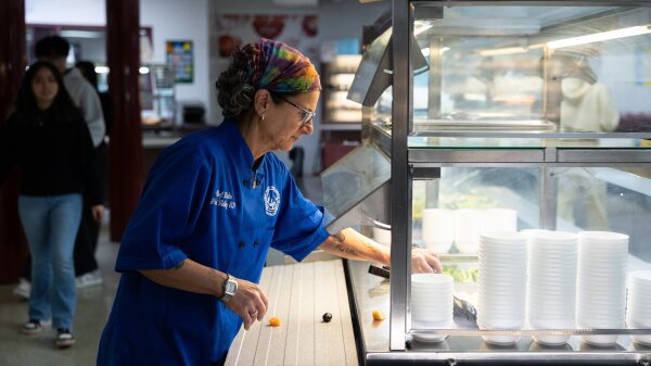 Great Valley School District culinary coordinator Jenifer Halin cleans up the salad bar in the cafeteria at a high school.