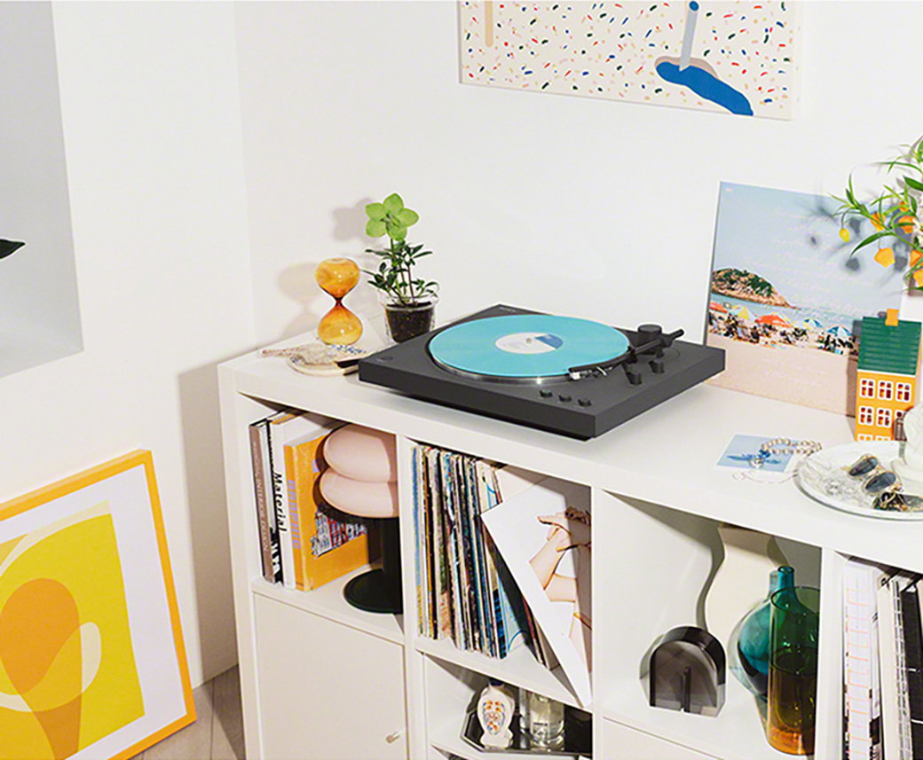 An image of a turntable on a white desk.