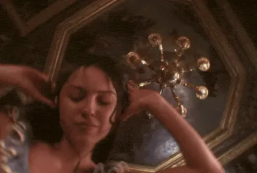 Olivia Rodrigo with headphones on jamming to herself in the "Drop dead" music video.