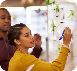 image-person-writing-on-whiteboard-as-colleague-looks-on