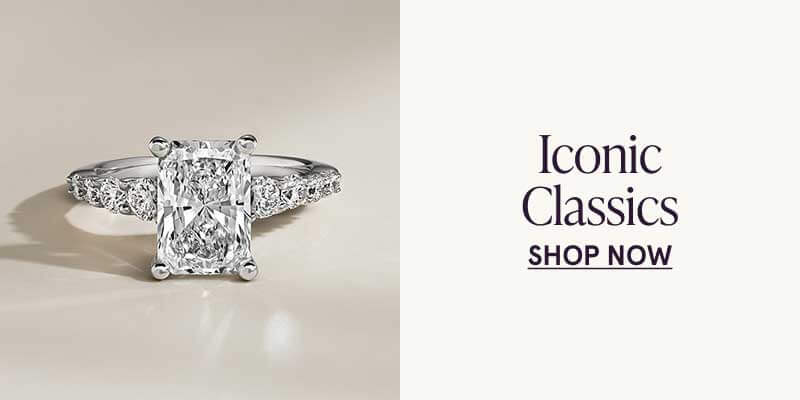 Silver-set ring showcasing emerald-cut diamond with band tapered with diamonds. Iconic classics. Click here to shop now