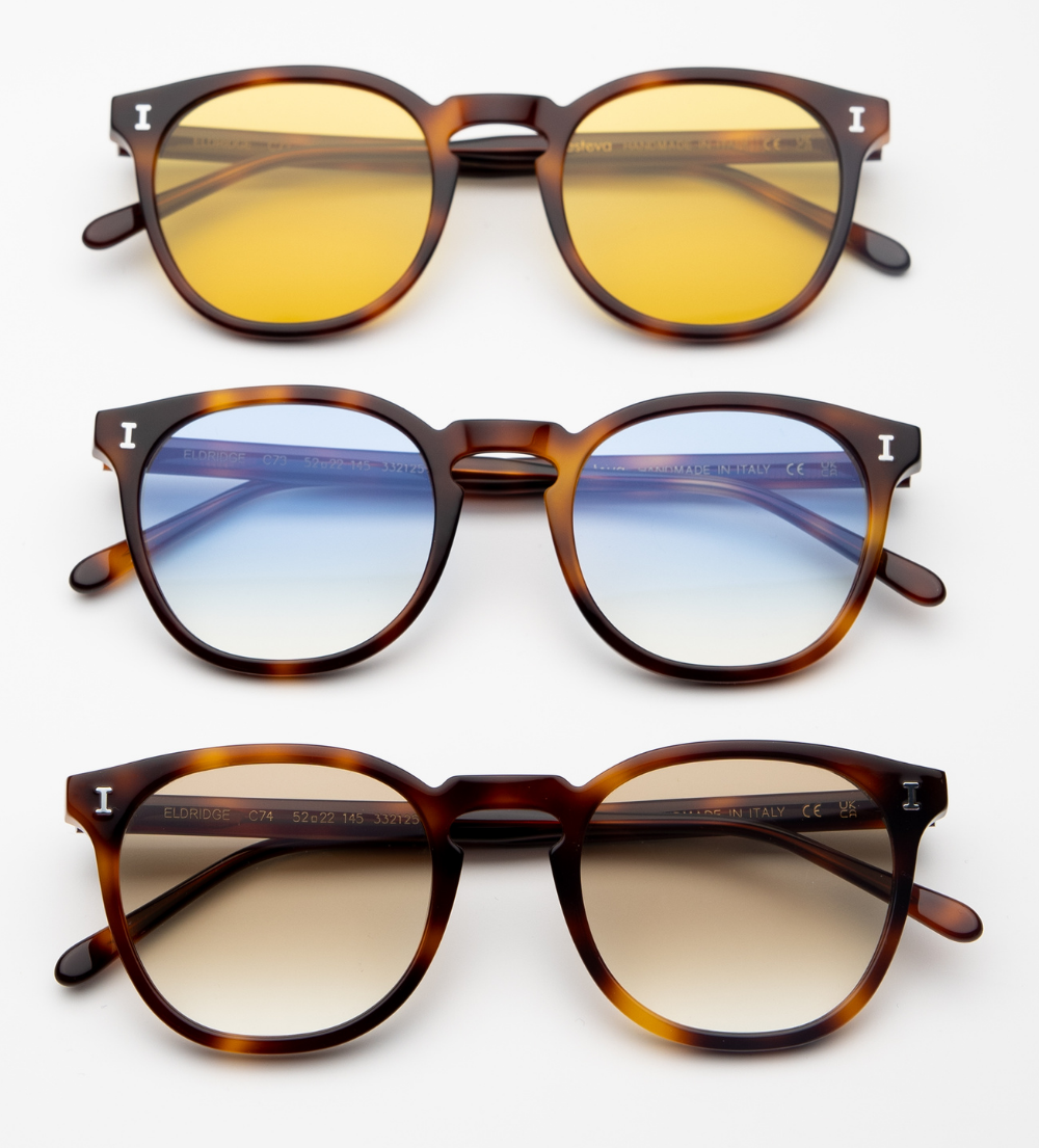 A vertical stack of three Eldridge frames, all in tortoise-shell acetate. The top pair has yellow lenses, the middle has light-blue gradient lenses, and the bottom has brown gradient lenses.