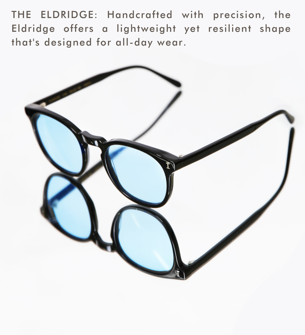 studio shot of the Eldridge frames in black with vibrant light-blue lenses, shown resting on a reflective white surface. Text at the top describes the frame as 