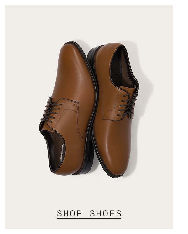 Pair of tan leather derby dress shoes with dark brown laces and black soles, shown from above against a light cream background. SHOP SHOES