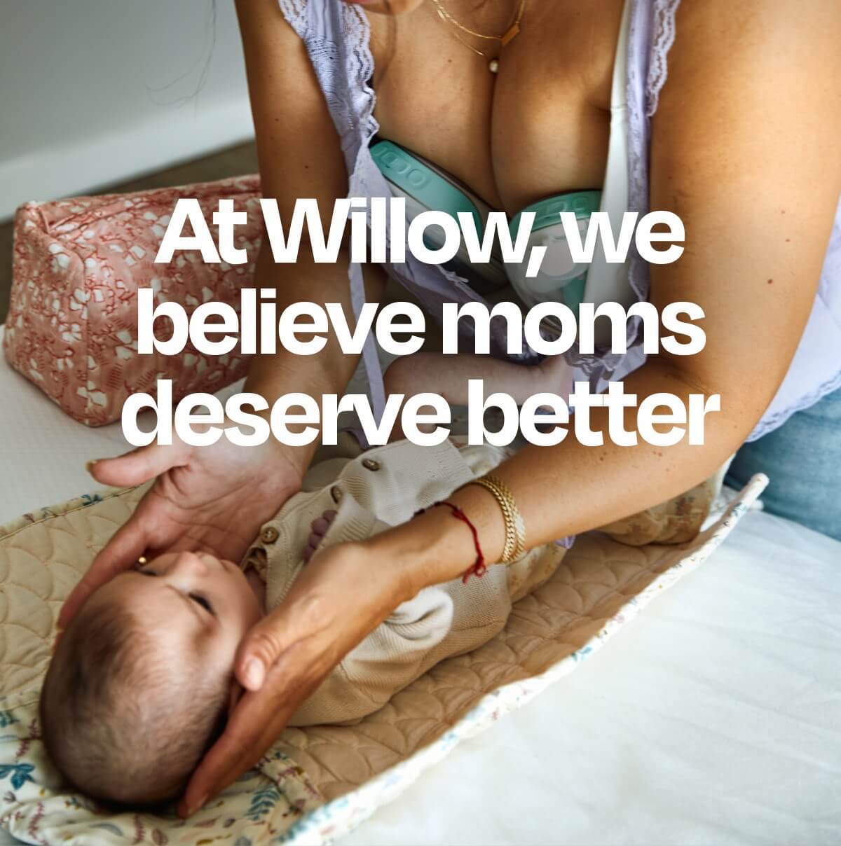 Mother using wearable breast pump while caring for baby