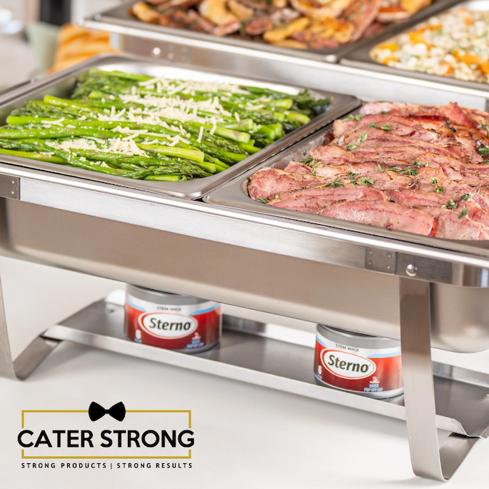 Cater Strong stainless steel chafing dish holding asparagus and sliced meat, heated with Sterno fuel beneath in a buffet presentation.