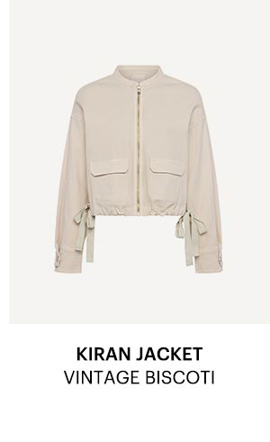 An image of a light cream colored jacket with tie waist detail - Shop the Kiran Jacket in Vintage Biscoti.