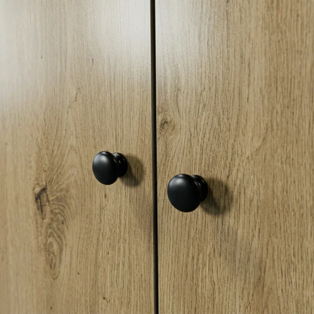 Selby matte black door knob close-up on oak door