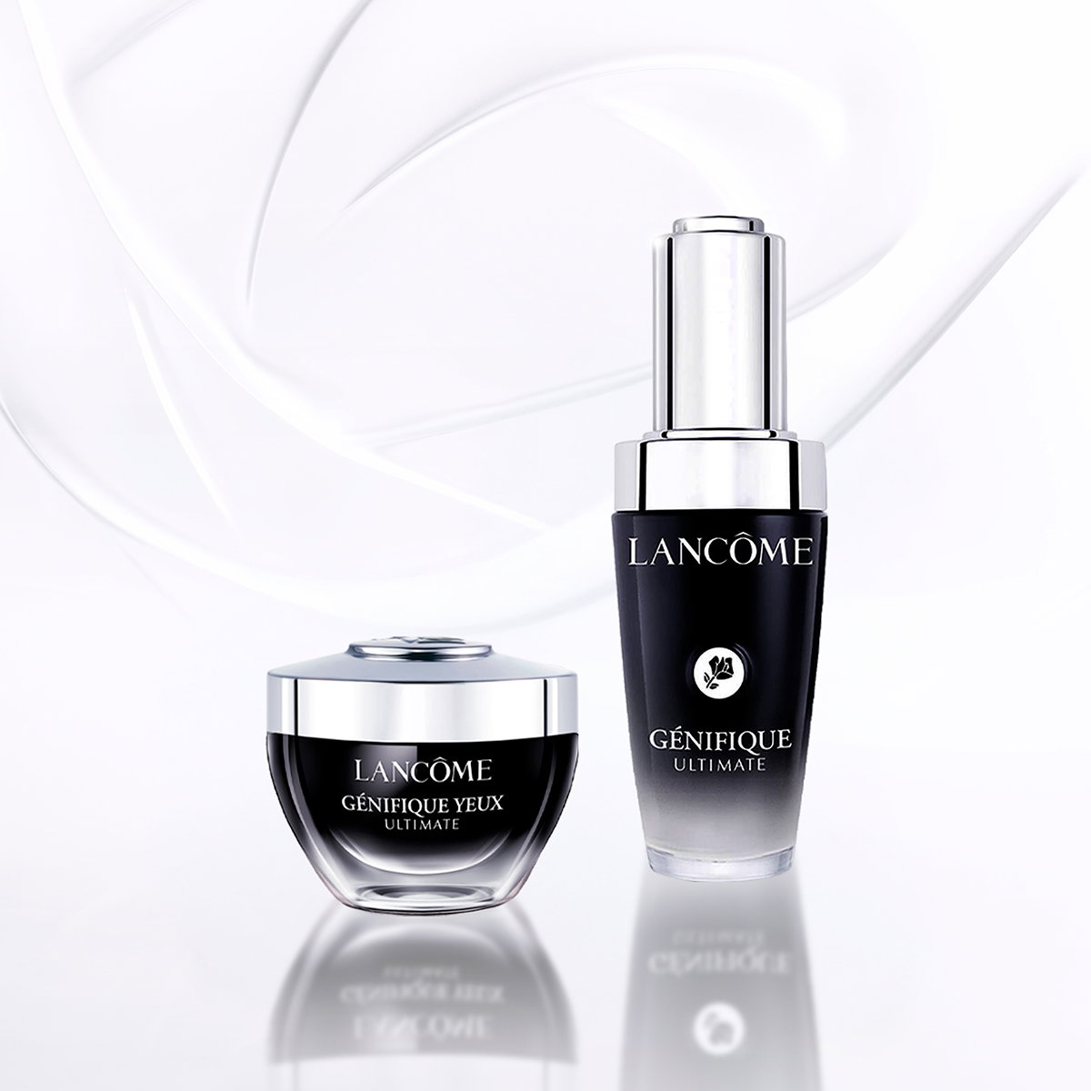 Duo Lancôme Génifique Ultimate: siero viso e crema contorno occhi in flaconi nero e argento su sfondo bianco