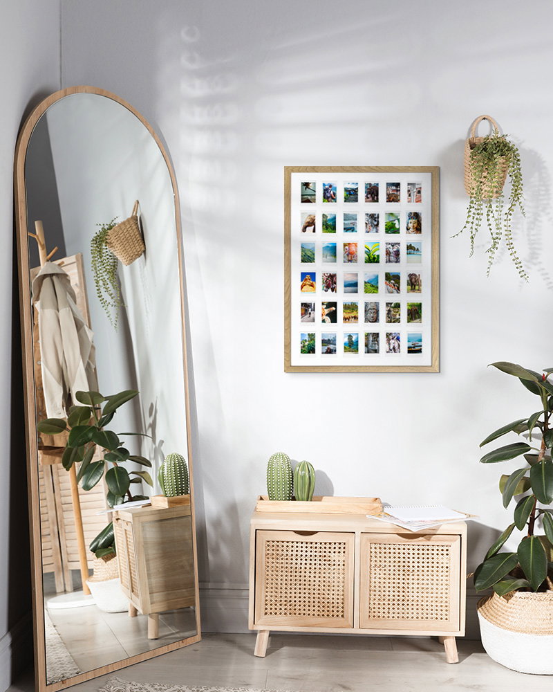 Large wooden Instax photo frame styled in modern boho interior