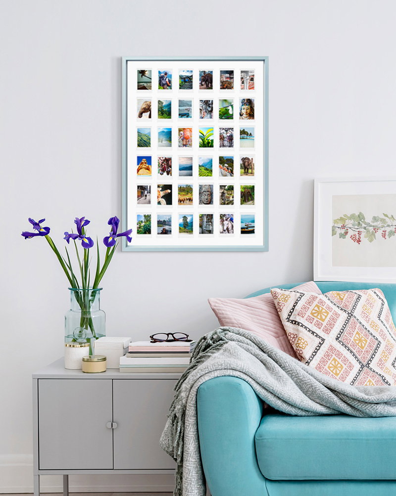 Pastel blue Instax collage frame above sofa and side table