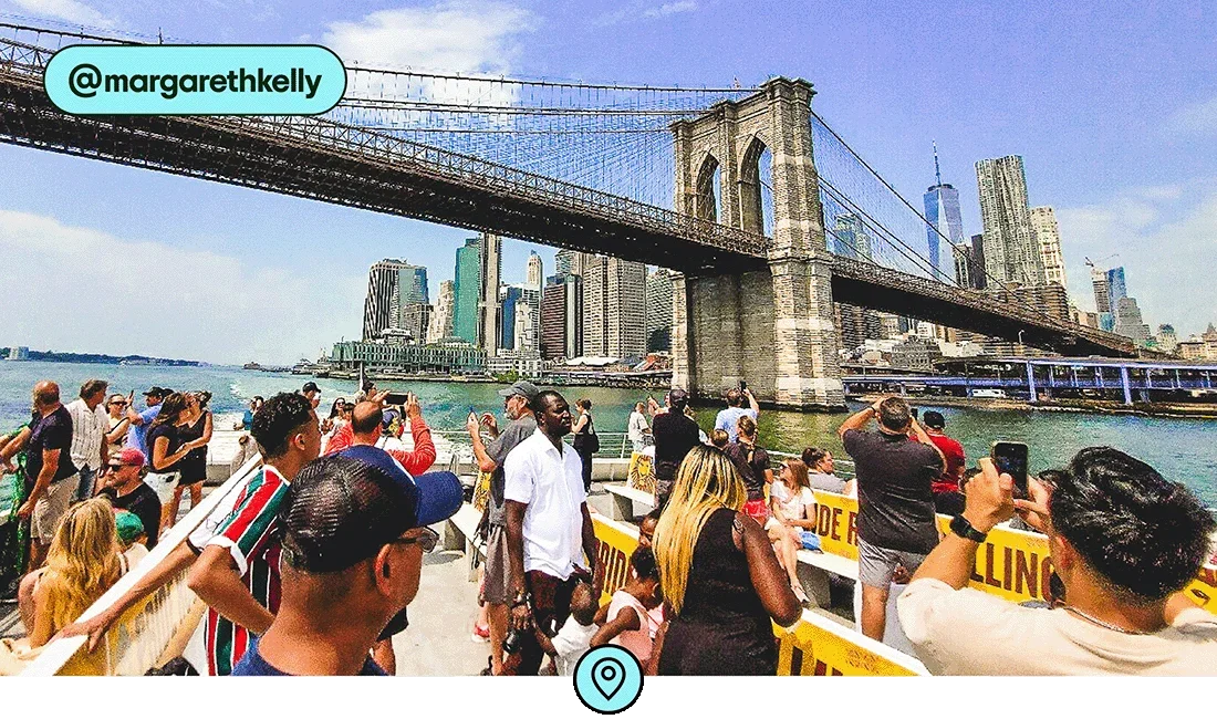 Image description: A view of the Brooklyn Bridge and lower Manhattan from the top level of a ferry, photo taken by @margarethkelly