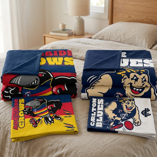 Two AFL Single Doona Covers laying on a bed folded