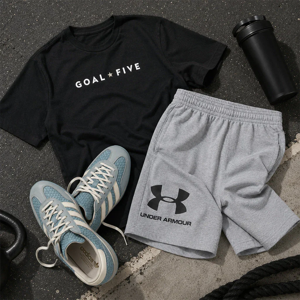 Men's Summer Reset outfit laid flat: black Goal Five t-shirt, gray Under Armour shorts, blue sneakers, and black water bottle.