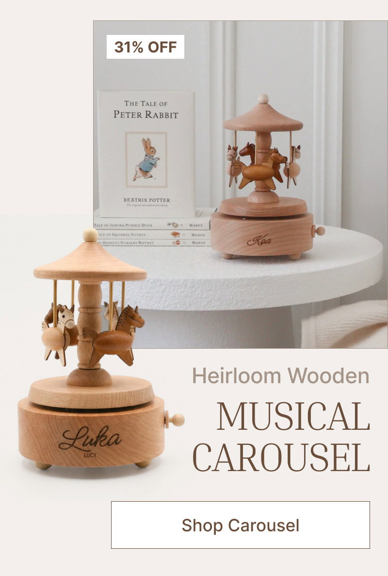 Wooden musical carousel on a white shelf beside nursery decor, with soft peach details and a small discount label.