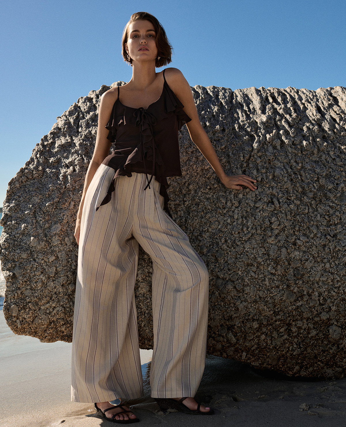Woman wearing Brown Ruffle Floaty Cami Top and Peach Mix Striped Wide Leg Trousers with Linen