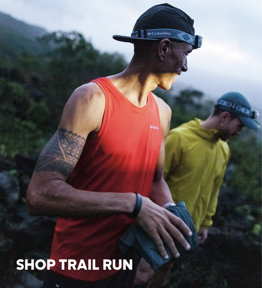 Two men standing in the outdoors wearing running gear and headlamps with text: SHOP TRAIL RUN