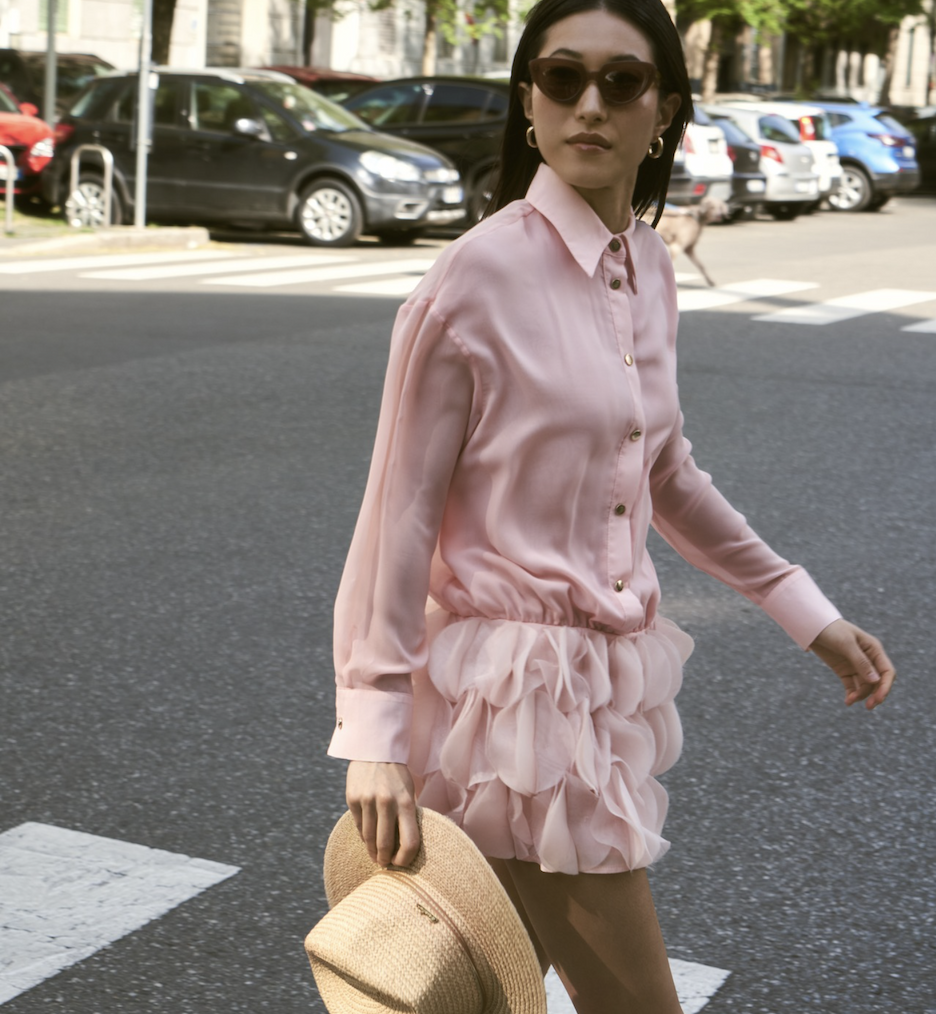 Woman in a tweed dress and Chanel bag.