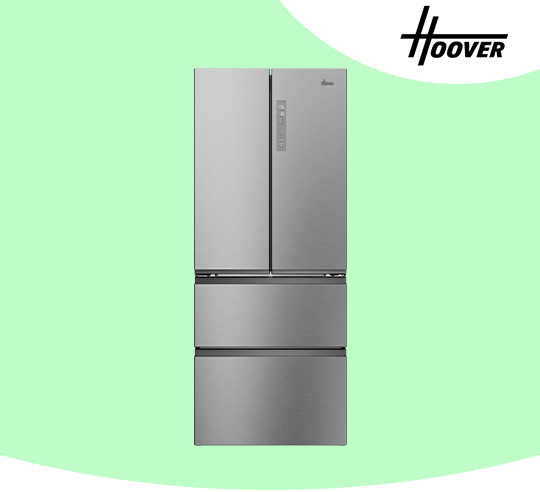 A stainless steel American fridge freezer against a green background.
