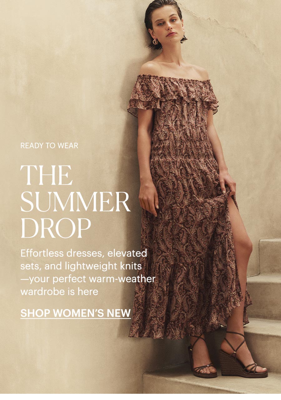 Woman wearing an off-shoulder mulholland paisley printed midi dress with brown wedge sandals, stood on a sunlit stone staircase. Ready to Wear: The Summer Drop - Effortless dresses, elevated sets, and lightweight knits—your perfect warm-weather wardrobe is here. Shop women's new arrivals.