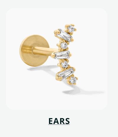 Gold flat-back labret stud with crawler top set with baguette & round stones. Click here to shop ears