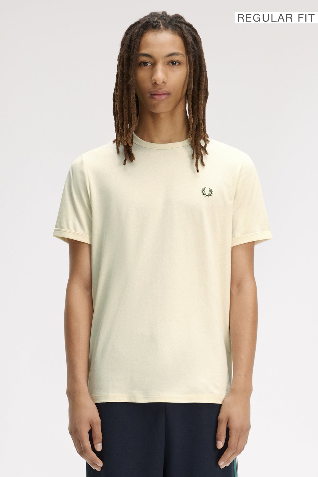 A male model wearing a Fred Perry Ringer T-Shirt in Ecru
