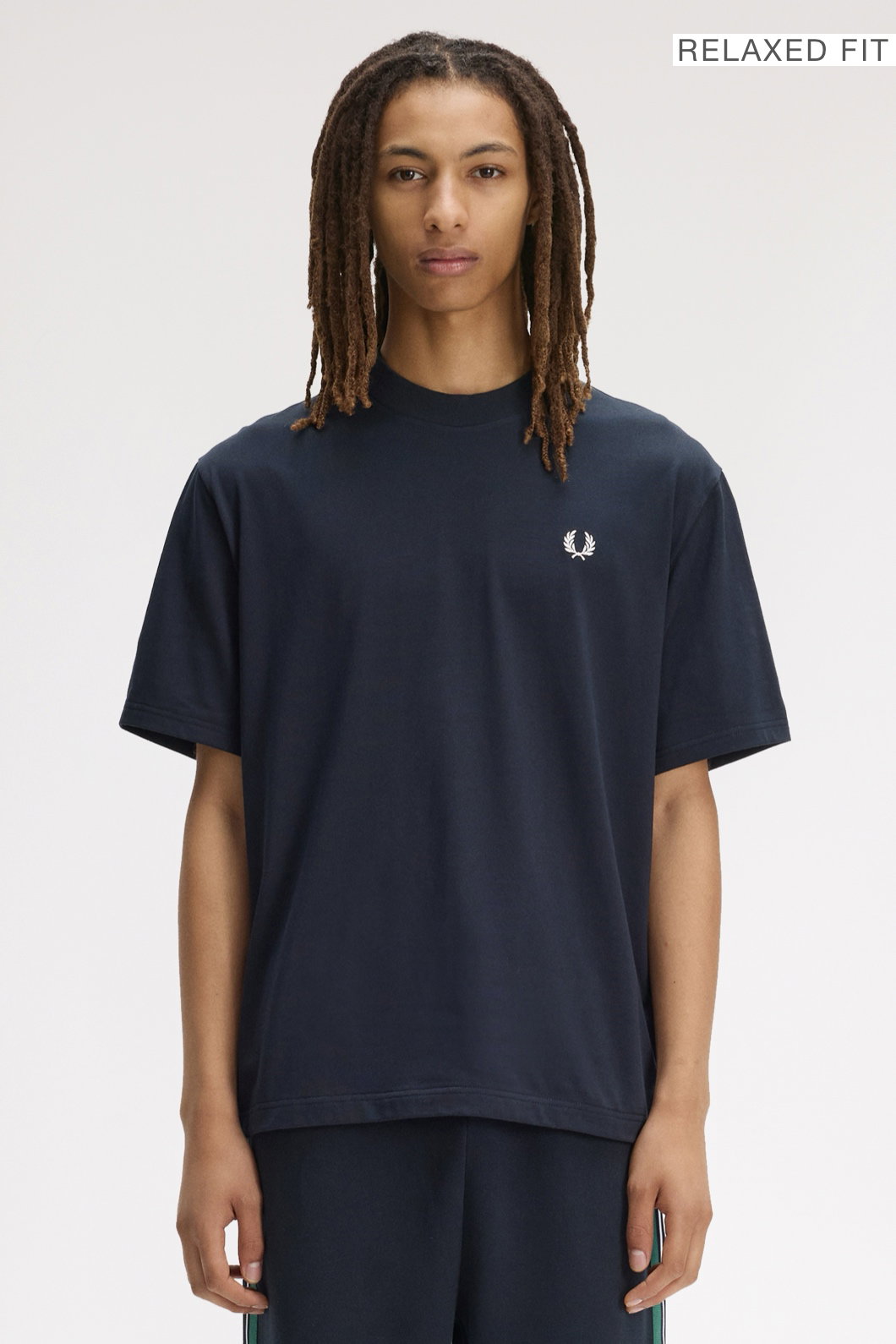 A male model wearing a Fred Perry Back Print Fred Perry Relaxed Fit T-Shirt in Navy