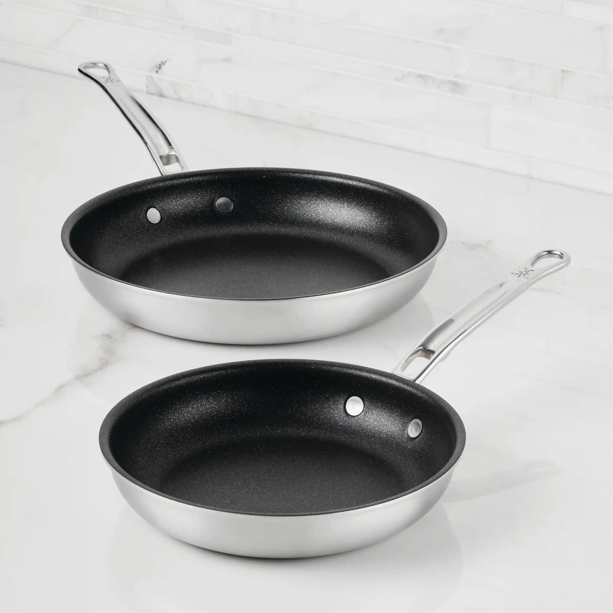 IMG: Commercial Clad Stainless Steel TITUM® Nonstick Skillets on marble countertop