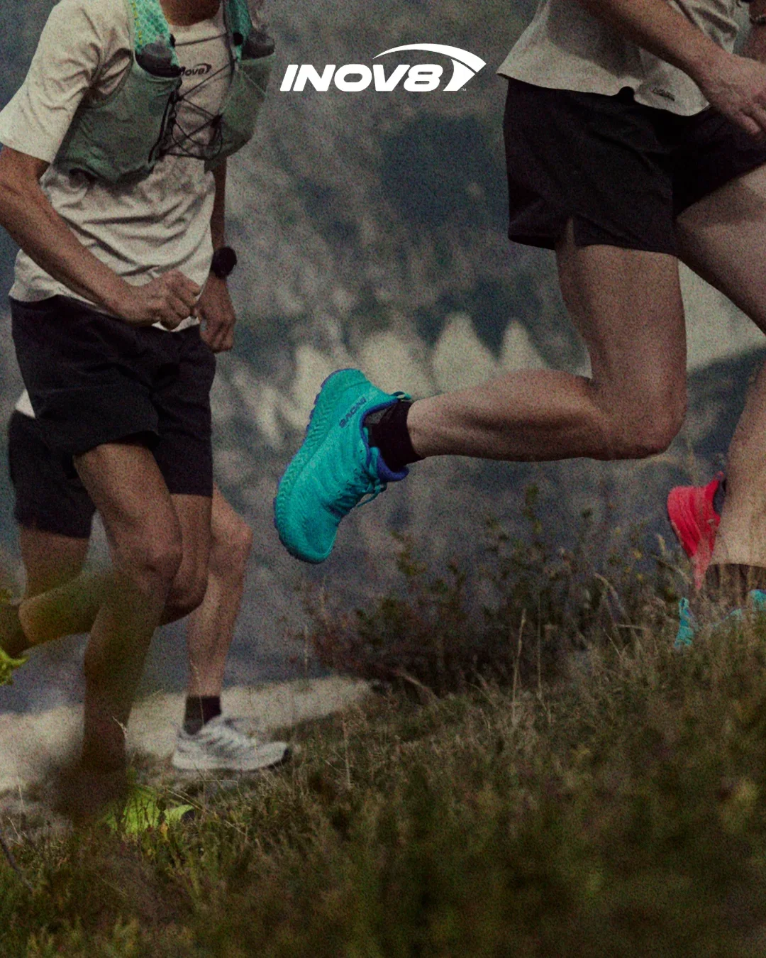 A runner wearing bold red TRAILFLY shoes