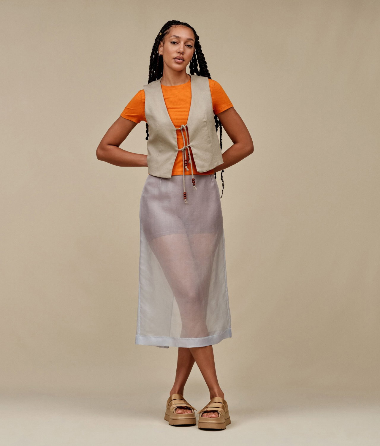 A studio shot of a model wearing the GoldenGlow Slide