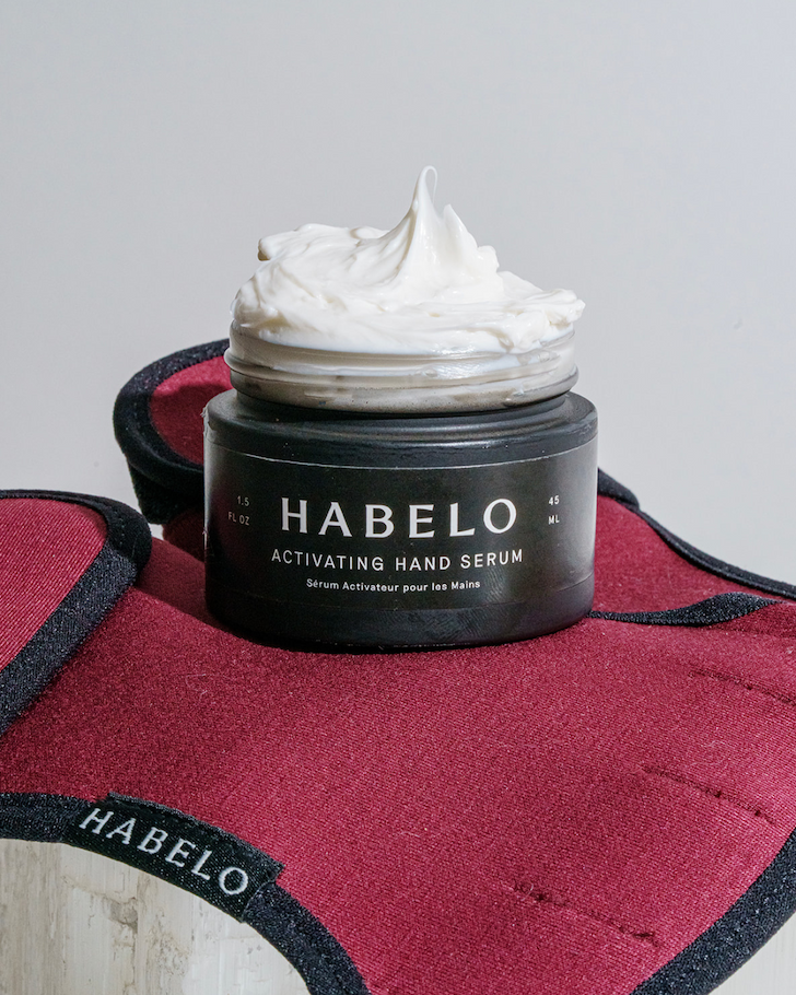 Habelo Activating Hand Serum with whipped texture shown on Bordeaux Treatment-Boosting Gloves.