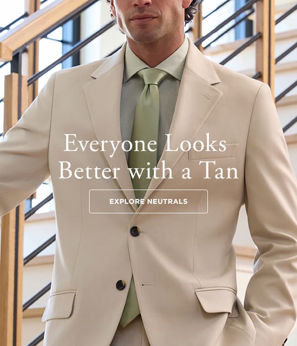 A man wears a tan suit and text says, "Everyone Looks Better with a Tan"