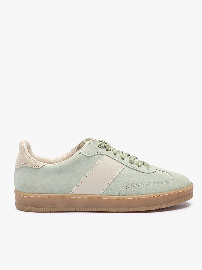 Light green and beige trainer with gum sole on white background.