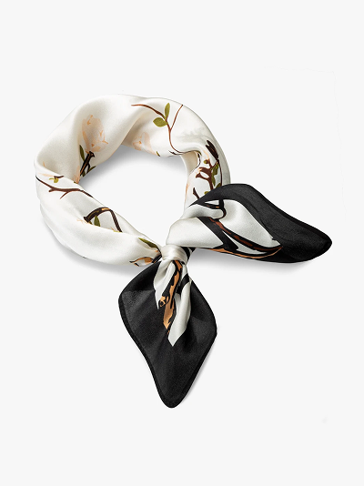 Elegant silk scarf with floral design and black border on white background.